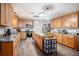 Well-lit kitchen with wooden cabinetry, an island, stainless appliances, and granite countertops at 3440 Pittman Rd, Dover, FL 33527