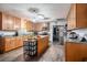 Well-lit kitchen featuring wood cabinetry, stainless steel appliances, and center island at 3440 Pittman Rd, Dover, FL 33527