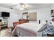 Main bedroom showcasing wood-look floors, a ceiling fan, and neutral paint at 3440 Pittman Rd, Dover, FL 33527
