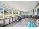 Spacious screened-in patio with various seating options and view of the backyard at 3440 Pittman Rd, Dover, FL 33527