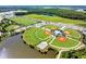 Aerial view of well-maintained baseball fields with surrounding trees, lake, and parking, showcasing community recreational facilities at 3984 Maurice Ave, Odessa, FL 33556