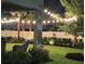 Enchanting backyard with string lights illuminating a patio and manicured garden, perfect for evening relaxation and entertainment at 3984 Maurice Ave, Odessa, FL 33556