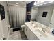 Well-lit bathroom featuring double sink vanity, modern fixtures, stylish decor, and a shower-tub combination for a spa-like experience at 3984 Maurice Ave, Odessa, FL 33556