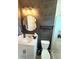 Contemporary bathroom featuring a round mirror, unique wallpaper, and modern fixtures at 3984 Maurice Ave, Odessa, FL 33556