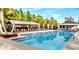 Beautiful community pool area surrounded by palm trees and lounge chairs, offering a resort-like atmosphere for residents at 3984 Maurice Ave, Odessa, FL 33556