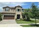 Charming two-story home with a well-manicured lawn and beautiful landscaping at 3984 Maurice Ave, Odessa, FL 33556