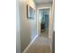 Inviting hallway with neutral paint, carpet, and an open doorway at 3984 Maurice Ave, Odessa, FL 33556
