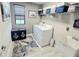 Well-lit laundry room featuring modern washer and dryer, storage shelves, sink and stylish decor for a functional space at 3984 Maurice Ave, Odessa, FL 33556