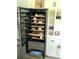Modern wine fridge with wooden shelving, a variety of wine, and a sliding drawer at 3984 Maurice Ave, Odessa, FL 33556