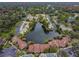 Beautiful aerial view of homes surrounding a serene lake in a lush, green landscape at 4114 Pinelake Ln # 202, Tampa, FL 33618