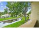 Picturesque view of the manicured backyard, featuring a serene water feature and lush trees enhancing the landscape at 4114 Pinelake Ln # 202, Tampa, FL 33618