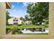 Scenic backyard view showcasing lush greenery, a tranquil pond, and charming bridge access to the property at 4114 Pinelake Ln # 202, Tampa, FL 33618