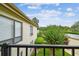 A charming balcony with a view of lush landscaping and a glimpse of the bright blue sky at 4114 Pinelake Ln # 202, Tampa, FL 33618