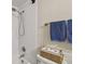Bathroom showcasing a shower, toilet, and towel rack with plush blue towels in a compact space at 4114 Pinelake Ln # 202, Tampa, FL 33618