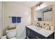 Bathroom with a navy blue vanity, modern fixtures, white countertop and plenty of décor at 4114 Pinelake Ln # 202, Tampa, FL 33618