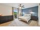 Comfortable bedroom with balcony access and a accent wall, filled with natural light at 4114 Pinelake Ln # 202, Tampa, FL 33618