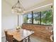 Bright dining area featuring a spacious table, modern lighting, and a large window offering natural light at 4114 Pinelake Ln # 202, Tampa, FL 33618