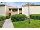 Charming condo featuring well-maintained landscaping and a inviting walkway leading to the front entrance at 4114 Pinelake Ln # 202, Tampa, FL 33618