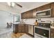 Updated kitchen with stainless steel appliances, dark cabinets, and a view to the dining room at 4114 Pinelake Ln # 202, Tampa, FL 33618