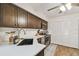 Well-lit kitchen features dark cabinets, quartz countertops, stainless steel appliances, and a modern design at 4114 Pinelake Ln # 202, Tampa, FL 33618