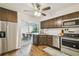 Well-equipped kitchen with stainless steel appliances, dark cabinets, and open layout to the dining area at 4114 Pinelake Ln # 202, Tampa, FL 33618