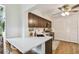 Bright kitchen featuring quartz countertops, dark cabinetry, breakfast bar, and modern appliances at 4114 Pinelake Ln # 202, Tampa, FL 33618