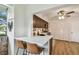 Bright kitchen featuring quartz countertops, dark cabinetry, breakfast bar, and modern appliances at 4114 Pinelake Ln # 202, Tampa, FL 33618