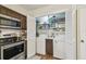 Conveniently placed laundry closet with appliances adjacent to a well-equipped kitchen with stainless steel features at 4114 Pinelake Ln # 202, Tampa, FL 33618