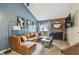 Comfortable living room with a brick fireplace, TV, and sectional sofa in a naturally lit interior at 4114 Pinelake Ln # 202, Tampa, FL 33618