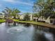 Scenic view of condos and the pond with a fountain and lush surroundings at 4114 Pinelake Ln # 202, Tampa, FL 33618
