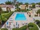 Aerial view of a community pool with lounge chairs and tables surrounded by lush landscaping at 4114 Pinelake Ln # 202, Tampa, FL 33618