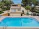 A swimming pool in a villa community, next to a deck with a table and view at 4114 Pinelake Ln # 202, Tampa, FL 33618