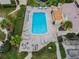 Aerial view of condo community pool area features plenty of seating and lush landscaping at 4114 Pinelake Ln # 202, Tampa, FL 33618