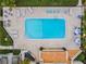 Overhead shot of community pool provides plentiful seating and surrounding lush landscaping at 4114 Pinelake Ln # 202, Tampa, FL 33618
