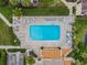Aerial view of the community pool area features plenty of seating and lush landscaping at 4114 Pinelake Ln # 202, Tampa, FL 33618