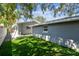 Spacious backyard features manicured green turf and exterior siding, perfect for outdoor activities at 483 32Nd N Ave, St Petersburg, FL 33704
