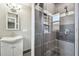 Modern bathroom featuring gray tiled shower with glass door and updated vanity at 483 32Nd N Ave, St Petersburg, FL 33704