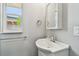Bathroom features a white vanity with a modern faucet and a window letting in natural light at 483 32Nd N Ave, St Petersburg, FL 33704
