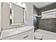This bathroom boasts dark tile, a marble vanity, and modern fixtures at 483 32Nd N Ave, St Petersburg, FL 33704