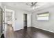 This bedroom features dark wood floors, a ceiling fan, closet, and a bright window at 483 32Nd N Ave, St Petersburg, FL 33704
