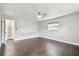 The bedroom features dark wood floors, a ceiling fan, and a bright window at 483 32Nd N Ave, St Petersburg, FL 33704