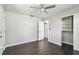 This bedroom features dark wood floors, a ceiling fan, closet and a neutral paint scheme at 483 32Nd N Ave, St Petersburg, FL 33704