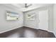 Neutral bedroom with wood floors, dual windows with roller shades, and a ceiling fan at 483 32Nd N Ave, St Petersburg, FL 33704