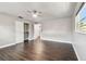 This bedroom features dark wood floors, a ceiling fan, closet and a neutral paint scheme at 483 32Nd N Ave, St Petersburg, FL 33704