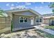 Charming home featuring updated gray paint, new windows, and inviting curb appeal with sidewalk leading to the front door at 483 32Nd N Ave, St Petersburg, FL 33704