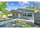 Charming home featuring updated gray paint, new windows, and inviting curb appeal with sidewalk leading to the front door at 483 32Nd N Ave, St Petersburg, FL 33704