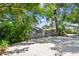 Charming home with a rustic wooden fence for privacy, mature trees, and gravel landscaping at 483 32Nd N Ave, St Petersburg, FL 33704