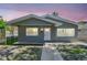 Charming home featuring updated gray paint, new windows, and inviting curb appeal with sidewalk leading to the front door at 483 32Nd N Ave, St Petersburg, FL 33704
