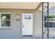Inviting front door with decorative glass, updated fixture, and a view of the manicured yard at 483 32Nd N Ave, St Petersburg, FL 33704
