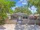 Charming home exterior featuring a fenced front yard and mature trees at 483 32Nd N Ave, St Petersburg, FL 33704